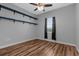 Bedroom with hardwood floors, a window and wall shelves to display décor at 9251 Geneva St, Spring Hill, FL 34608