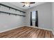 Bedroom with hardwood floors, a window and wall shelves to display décor at 9251 Geneva St, Spring Hill, FL 34608