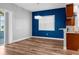 Dining area with modern lighting, a bold blue accent wall, and patio access at 9251 Geneva St, Spring Hill, FL 34608