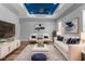Bright living room with stylish furniture, modern decor, and a blue accent tray ceiling at 9251 Geneva St, Spring Hill, FL 34608