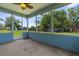 A screened lanai featuring durable flooring and views of the grassy backyard, perfect for outdoor enjoyment at 9251 Geneva St, Spring Hill, FL 34608
