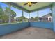 A relaxing screened porch features neutral concrete floors and serene views of the surrounding landscape at 9251 Geneva St, Spring Hill, FL 34608