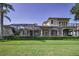 Spacious backyard featuring lush landscaping, a screened pool, and an elevated balcony at 9933 Milano Dr, Trinity, FL 34655