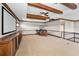 Entertaining basement with projector screen, bar area, and wood beam ceiling at 9933 Milano Dr, Trinity, FL 34655