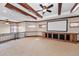 Entertaining basement with projector screen, bar area, and wood beam ceiling at 9933 Milano Dr, Trinity, FL 34655