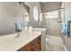 Cozy bathroom features a shower-tub combo, a vanity with drawers, and a framed mirror at 9933 Milano Dr, Trinity, FL 34655