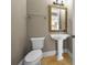 Classic powder room with pedestal sink, decorative mirror, and tile flooring at 9933 Milano Dr, Trinity, FL 34655