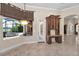 Bright dining area featuring large windows with views of the pool and a built-in desk with storage at 9933 Milano Dr, Trinity, FL 34655