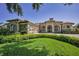 Stunning home features a manicured lawn, stone accents, and a three-car garage at 9933 Milano Dr, Trinity, FL 34655