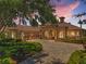 Beautiful home features a manicured lawn, stone accents, and a three-car garage at 9933 Milano Dr, Trinity, FL 34655