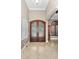 Grand foyer featuring double front doors, tile flooring, and an arched doorway at 9933 Milano Dr, Trinity, FL 34655
