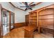 A home office with wood paneled walls, built in shelving and desk with plenty of natural light at 9933 Milano Dr, Trinity, FL 34655