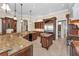 Open kitchen with a large island, granite countertops, and stainless steel appliances at 9933 Milano Dr, Trinity, FL 34655