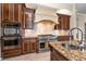 Kitchen featuring stainless steel appliances, granite countertops, and custom cabinetry at 9933 Milano Dr, Trinity, FL 34655