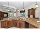 Gourmet kitchen boasting granite countertops, custom cabinets, and a breakfast bar overlooking scenic views at 9933 Milano Dr, Trinity, FL 34655