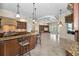 Gourmet kitchen boasting granite countertops, custom cabinets, and a breakfast bar overlooking the living area at 9933 Milano Dr, Trinity, FL 34655