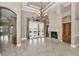 Spacious living room with tile flooring, fireplace, and French doors leading to the outdoor area at 9933 Milano Dr, Trinity, FL 34655