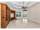 Open living room featuring a custom built-in entertainment center and French doors to the outdoors at 9933 Milano Dr, Trinity, FL 34655