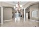 Open floor plan with tile floors, decorative columns, a chandelier and views of adjoining living spaces at 9933 Milano Dr, Trinity, FL 34655