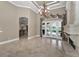 Bright living room showing tile flooring, arched doorways, and a view to the kitchen and outdoor space at 9933 Milano Dr, Trinity, FL 34655
