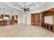 Open-concept living area with kitchen, custom built-ins, and tile flooring throughout, perfect for entertaining at 9933 Milano Dr, Trinity, FL 34655