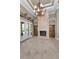 Cozy living room with a fireplace, tile floors and views to the outside at 9933 Milano Dr, Trinity, FL 34655