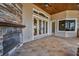 Outdoor entertaining is made easy with a stone fireplace, tiled patio, and plenty of natural light at 9933 Milano Dr, Trinity, FL 34655