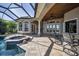 Inviting screened outdoor space features a pool, hot tub, and bar seating, perfect for relaxing and entertaining at 9933 Milano Dr, Trinity, FL 34655