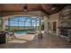 Relaxation awaits in this outdoor space complete with a hot tub, pool and stone fireplace at 9933 Milano Dr, Trinity, FL 34655