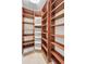 Spacious walk-in pantry featuring custom wood shelving and convenient storage solutions at 9933 Milano Dr, Trinity, FL 34655