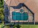 Aerial view of the screened pool and attached hot tub beside a patio and brown shingled roof at 9933 Milano Dr, Trinity, FL 34655