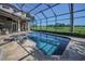 Inviting screened-in pool with a spa offers a relaxing retreat and scenic golf course views at 9933 Milano Dr, Trinity, FL 34655