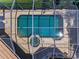 Overhead view of a screened in pool and spa, with patio and lush surroundings at 9933 Milano Dr, Trinity, FL 34655
