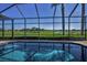 Capture the tranquility of the pool, set against the backdrop of a golf course and clear blue sky at 9933 Milano Dr, Trinity, FL 34655