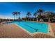 Resort-style pool area featuring a pool, brick pavers, and palm trees at 9933 Milano Dr, Trinity, FL 34655