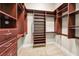 Well-organized walk-in closet with custom wooden shelving and ample storage space at 9933 Milano Dr, Trinity, FL 34655