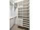 Organized walk-in closet with white shelves and drawers provides efficient storage solutions at 9933 Milano Dr, Trinity, FL 34655