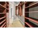 Spacious walk-in closet with wooden shelves and drawers provides ample storage and organization at 9933 Milano Dr, Trinity, FL 34655