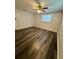 Bedroom with neutral walls, a ceiling fan, and new flooring at 10014 Kingswood Ln, Port Richey, FL 34668