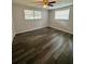 Bedroom featuring new flooring, neutral paint, and natural light from the windows at 10014 Kingswood Ln, Port Richey, FL 34668
