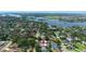Aerial view of neighborhood with mature trees, waterfront views, and access to nearby waterways at 1004 Peninsula Ave, Tarpon Springs, FL 34689