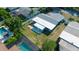 Aerial view of house with backyard, patio, and fencing between neighbors, enhanced by surrounding trees at 1004 Peninsula Ave, Tarpon Springs, FL 34689