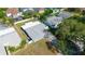 Aerial view of the property showcasing the roof, back yard and fencing, situated in a neighborhood at 1004 Peninsula Ave, Tarpon Springs, FL 34689