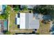 Aerial view of property showcasing backyard pool, and a white fence at 1004 Peninsula Ave, Tarpon Springs, FL 34689