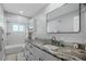 Bathroom features updated vanity with granite counters and tub with shower at 1004 Peninsula Ave, Tarpon Springs, FL 34689