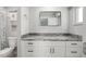 Bathroom features updated vanity with granite counters and a large mirror at 1004 Peninsula Ave, Tarpon Springs, FL 34689