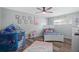 Charming bedroom with playful decor, natural light, and wood-look flooring at 1004 Peninsula Ave, Tarpon Springs, FL 34689