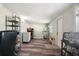Bright bonus room with wood flooring, storage, exercise equipment and a utility closet at 1004 Peninsula Ave, Tarpon Springs, FL 34689