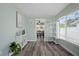 View of the dining area and access to the living space, both with wood-style flooring at 1004 Peninsula Ave, Tarpon Springs, FL 34689