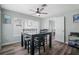 Dining room featuring wood-look floors, a modern table, and natural light at 1004 Peninsula Ave, Tarpon Springs, FL 34689